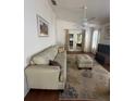 Bright living room boasts vaulted ceilings, ceiling fan, and sliding glass doors at 2127 N.E. 40Th Ave., Ocala, FL 34470