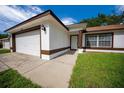 Charming one-story home with a well-maintained lawn and attached two-car garage at 2312 Sw 140Th Ct, Ocala, FL 34481