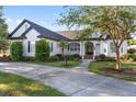 Charming single-story home boasts a meticulously landscaped yard and inviting curb appeal, enhanced by a well-lit walkway at 4083 Se 38Th Loop, Ocala, FL 34480
