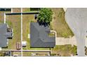 Aerial view of a home with a dark roof, fenced yard, and lush greenery at 4939 Sw 99Th Pl, Ocala, FL 34476