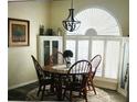 Bright dining area with a round table, seating for four, updated light fixture, and modern flooring at 5281 Sw 33Rd St, Ocala, FL 34474