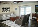 Cozy living room features comfortable seating, a ceiling fan, and a sliding glass door for natural light at 5281 Sw 33Rd St, Ocala, FL 34474