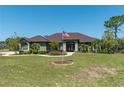 Inviting single-story home showcases lush landscaping, a charming walkway, and the American flag at 6045 Ne 65Th St, Silver Springs, FL 34488