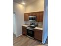 Kitchen featuring wooden cabinetry, a stainless steel oven, microwave, and solid surface countertops at 627 Vagabond St, The Villages, FL 32163