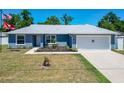 Inviting home featuring a manicured front lawn and attached garage, providing both curb appeal and convenience at 6671 Se 108Th St, Belleview, FL 34420