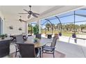 Relaxing screened patio features dining area, ceiling fans, a hot tub, and scenic golf course views at 7503 Sw 97Th Terrace Rd, Ocala, FL 34481