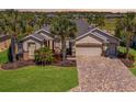 Well maintained home with a 3-car garage, paver driveway, mature landscaping, and beautiful curb appeal at 7503 Sw 97Th Terrace Rd, Ocala, FL 34481