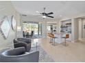 Open-concept living room offers sliding glass doors to screened porch and bar seating for entertaining at 7503 Sw 97Th Terrace Rd, Ocala, FL 34481