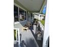 Cozy front porch with neutral paint, bright sunlight, and cute decor at 8107 Sw 108Th Place Rd, Ocala, FL 34481