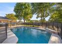 Sparkling pool featuring a waterfall feature and a secure safety fence at 8215 Sw 53Rd Ct, Ocala, FL 34476