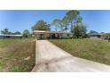 Charming single-story home featuring a covered carport and a long driveway at 10040 Sw 93Rd Ct, Ocala, FL 34481