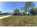 Charming single-story home featuring a covered carport and a well-maintained front yard at 10040 Sw 93Rd Ct, Ocala, FL 34481