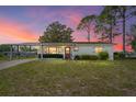 Charming single-story home featuring a covered carport and a well-maintained front yard at 10040 Sw 93Rd Ct, Ocala, FL 34481