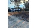 Distant view of a quaint home with metal roof, screened porch, and a spacious yard at 11921 Se 169Th Avenue Rd, Ocklawaha, FL 32179
