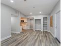 Open-concept living room featuring new flooring, neutral paint, and an opening to the kitchen, offering an inviting atmosphere at 1325 42Nd St, Orlando, FL 32839