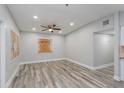 Spacious living room showcasing neutral gray walls, modern flooring, ceiling fan, and natural light from the adjacent spaces at 1325 42Nd St, Orlando, FL 32839