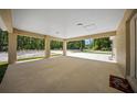 Spacious covered carport with exposed support beams providing ample covered parking with an entrance to the backyard at 13491 E Hwy 316, Fort Mc Coy, FL 32134