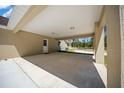 Attached carport offering covered parking and a convenient entrance to the home's exterior door at 13491 E Hwy 316, Fort Mc Coy, FL 32134