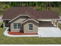 A high angle view of this one-story home shows the attached carport and neutral stucco exterior finish at 13491 E Hwy 316, Fort Mc Coy, FL 32134