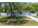 Attractive single-story home with a fresh concrete driveway, fenced yard and mature tree at 14476 Sw 43Rd Court Rd, Ocala, FL 34473