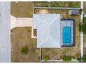 Aerial view of property featuring a screened-in pool, fenced in yard and mature landscaping at 1453 Ne 161St Pl, Citra, FL 32113