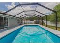 Inviting screened-in pool area with clear blue water, perfect for relaxation and outdoor enjoyment at 1453 Ne 161St Pl, Citra, FL 32113