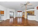 Spacious living room with hardwood floors, and neutral paint with an archway leading to the kitchen at 15239 Sw 15Th Terrace Rd, Ocala, FL 34473