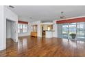 Open living room featuring hardwood floors, neutral paint, and sliding glass doors leading to the lanai at 15239 Sw 15Th Terrace Rd, Ocala, FL 34473