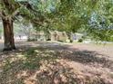 Single-story home with mature tree shading the front yard at 26 Hemlock Circle Way, Ocala, FL 34472