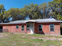 Charming single-story home featuring an entrance porch, a metal roof and several windows at 2630 Nw 140Th St, Citra, FL 32113