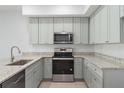 Well-equipped kitchen featuring stainless steel appliances, light gray cabinets, and granite countertops at 288 N Oak Ave, Sanford, FL 32771