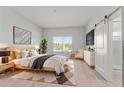 Serene main bedroom with wood-look floors, natural light, and stylish modern decor at 288 N Oak Ave, Sanford, FL 32771