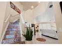 Welcoming foyer featuring high ceilings, colorful stair risers, and easy access to the living area at 3970 Sw 51St Ter, Ocala, FL 34474