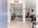 Open-concept living area with neutral colors, tile entryway, and plenty of natural light at 4881 Se 91St Pl, Ocala, FL 34480
