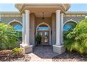 Inviting front entrance with stone pillars and lush landscaping creates a grand welcome at 5090 Nw 80Th Avenue Rd, Ocala, FL 34482