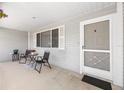 Inviting covered porch with seating area, perfect for relaxing outdoors at 8237 108Th Street Sw Rd, Ocala, FL 34481