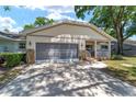 Charming single-story home showcasing a covered front porch, and a two-car garage at 8831 Sw 94Th Ln # H, Ocala, FL 34481
