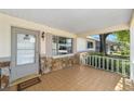 Inviting covered front porch with stone accents, white railings, and tile flooring at 8831 Sw 94Th Ln # H, Ocala, FL 34481