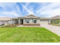 Beautiful single-story home featuring an attached two car garage and a paved driveway at 9945 Sw 83Rd Ln, Ocala, FL 34481
