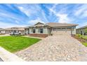 Beautiful single-story home featuring an attached two car garage and a paved driveway at 9945 Sw 83Rd Ln, Ocala, FL 34481