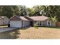 Lovely single-story home featuring an attached garage, manicured landscaping, and a cozy atmosphere at 10 Banyan Track Way, Ocala, FL 34472