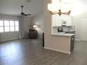 Bright and airy living room with a ceiling fan flows into a kitchen with modern finishes at 11536 Sw 138Th Ln, Dunnellon, FL 34432