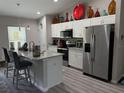 Modern kitchen featuring stainless steel appliances, granite countertops, and a spacious island at 13356 Sw 66Th St, Ocala, FL 34481