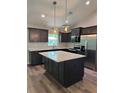 Modern kitchen with stainless steel appliances, island, and wooden cabinets at 13506 Sw 114Th Ln, Dunnellon, FL 34432
