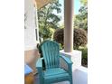Comfortable front porch with a chair, perfect for relaxing and enjoying the outdoor views at 19059 Sw 92Nd Loop, Dunnellon, FL 34432