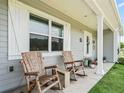 Charming front porch with rocking chairs and a view of the landscaped yard at 2780 Ne 127Th Pl, Anthony, FL 32617