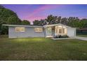 Attractive home with a well-maintained lawn is basked in the evening's glow at 3810 Sw 5Th Ave, Ocala, FL 34471