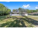 Nice single-story home with gray brick, large front yard and beautiful mature shade trees at 3810 Sw 5Th Ave, Ocala, FL 34471