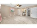 Large main bedroom featuring neutral carpet, a ceiling fan and a vanity area at 3834 Se 9Th Pl, Ocala, FL 34471