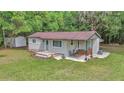 Aerial shot of a single-story home with green lawn, storage shed and covered porch at 4180 W Anthony Rd, Ocala, FL 34475